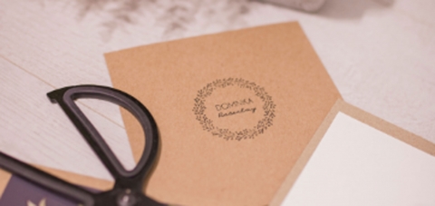 sciccors on top of invites and envelopes