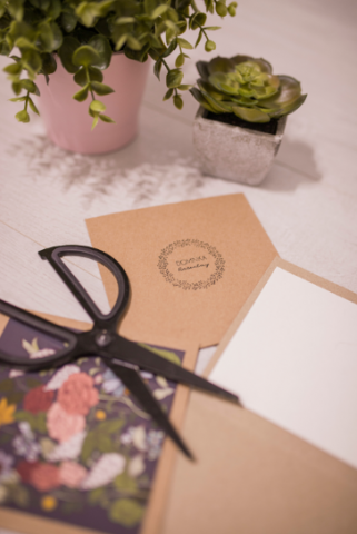 Sciccors on top of invites, next to flowers