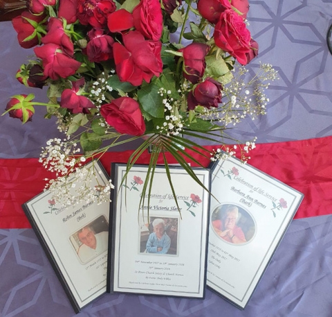 Some example eulogies next to red roses