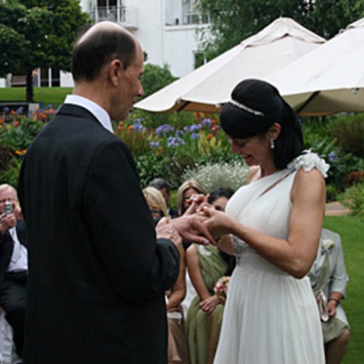 A man and women couple taking their vows at their wedding