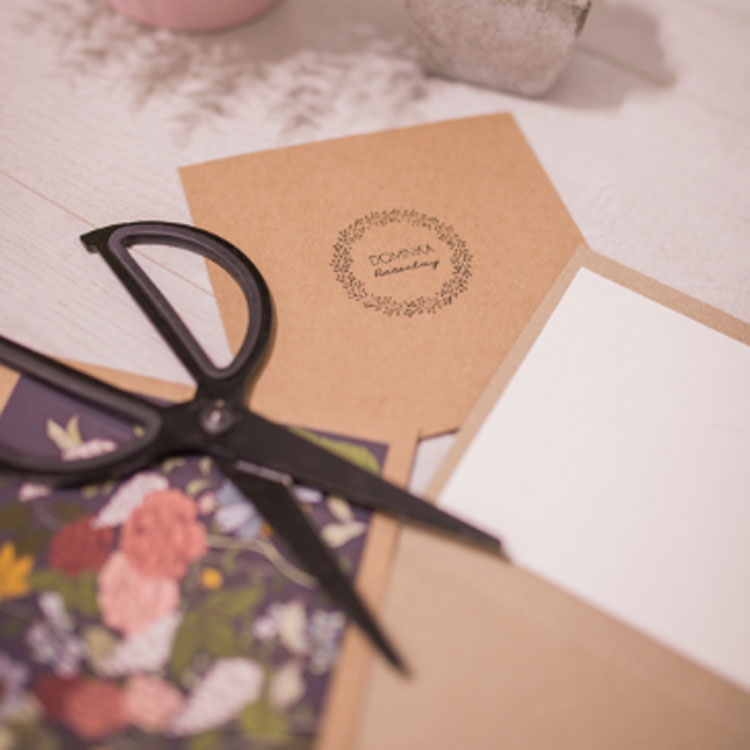 Sciccors on top of invitations and envelopes