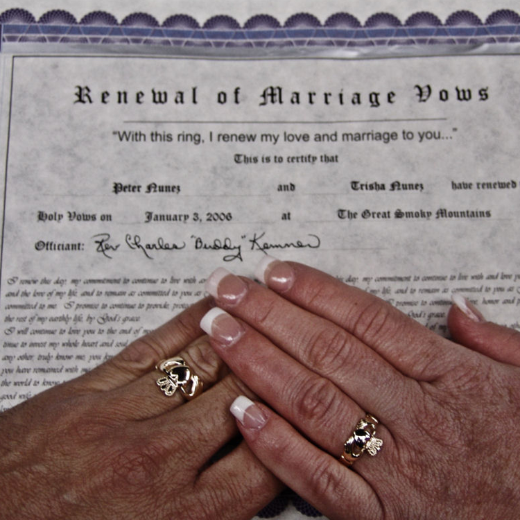 Man and women's hands over their vow renewals