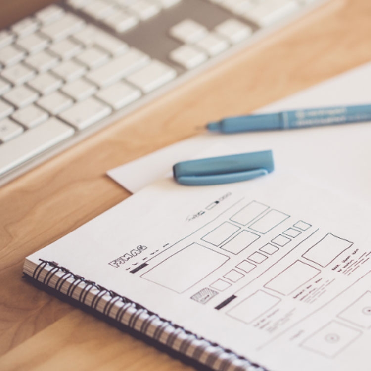 Pen on top of paper with design drawings