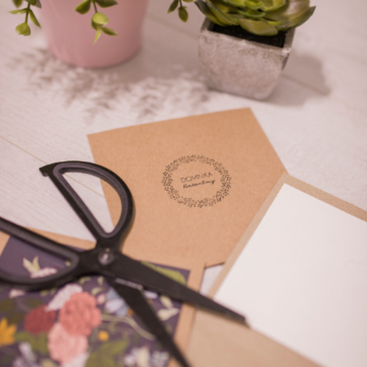 Sciccors on top of invites, next to flowers